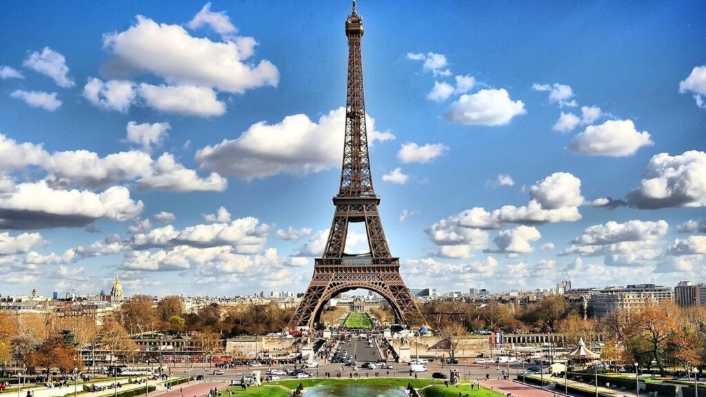 Best cities to visit in Europe: The Eiffel Tower, Paris, on a sunny day with beautiful clouds.